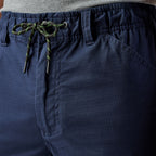 Close up waist detail of a pair of navy blue cargo style FXD Men's WP-12 Elastic Waist Stretch Ripstop Work Pants (FX02506026) on a white background.