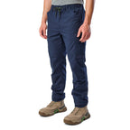 A 3-4 front view of a man wearing navy blue cargo style FXD Men's WP-12 Elastic Waist Stretch Ripstop Work Pants (FX02506026) with stone coloured work boots on a white background.