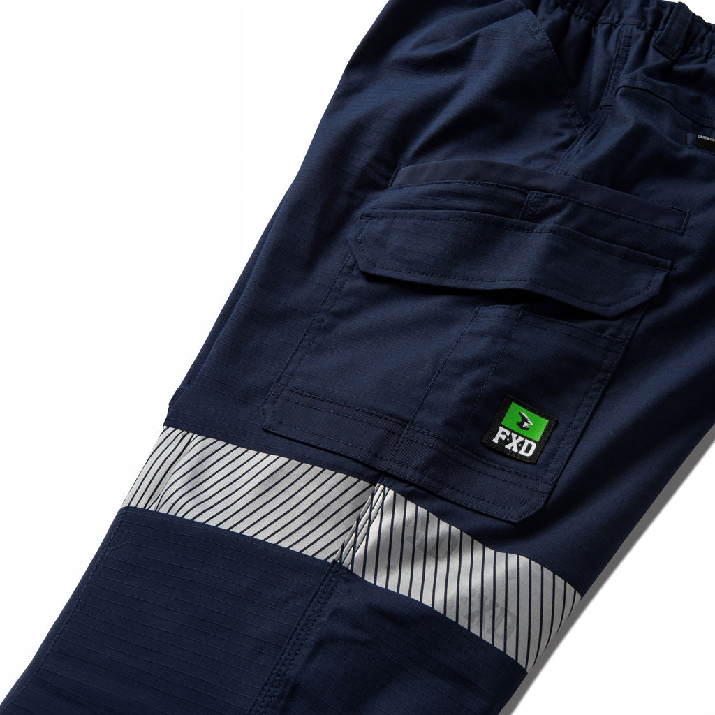 Close up flat lay pocket detail of a pair of navy blue FXD Men's WP-12T Elastic Waist Stretch Ripstop Taped Work Pants (FX02606028) on a white background.