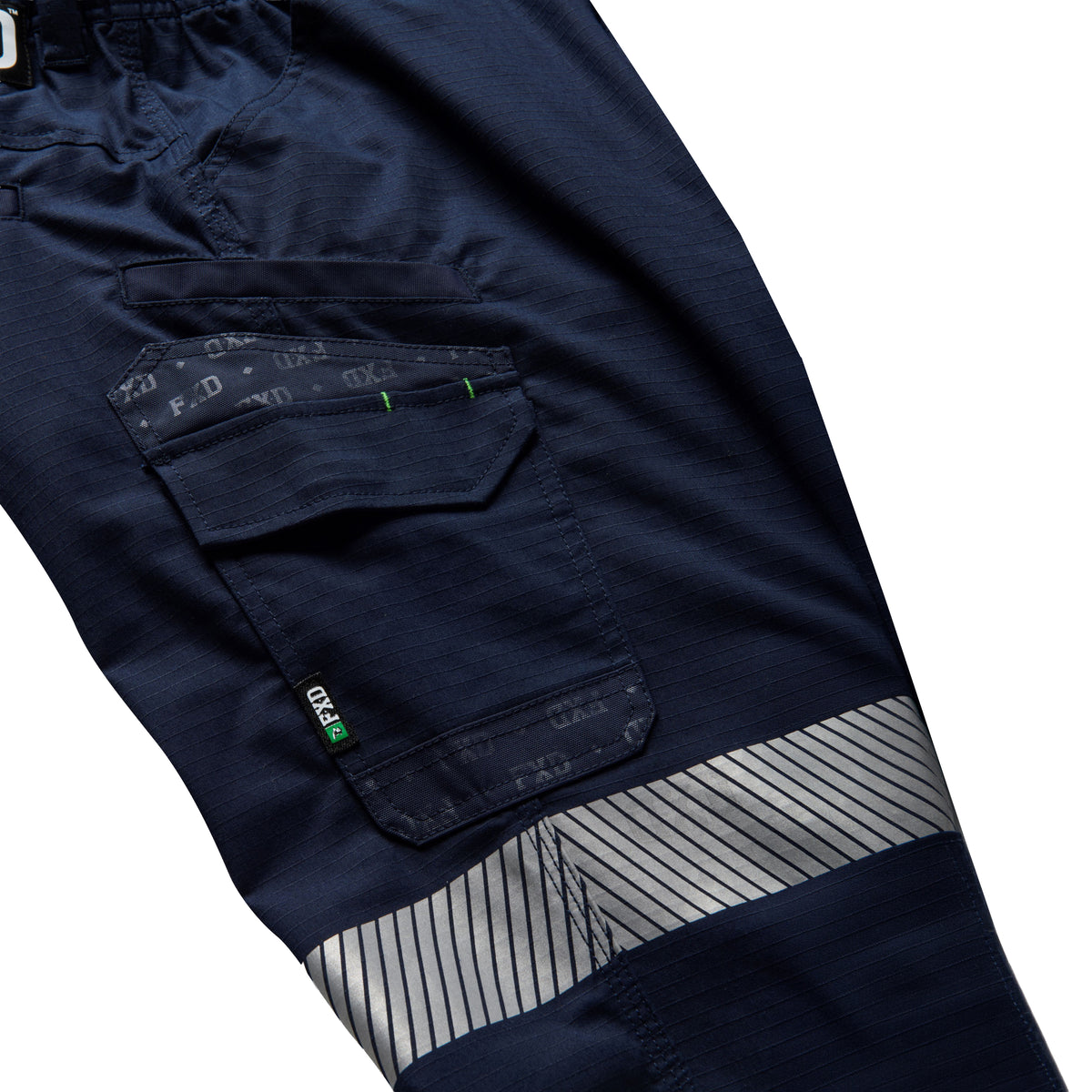 Close up flat laid pocket detail of a pair of navy blue FXD Men's WP-12T Elastic Waist Stretch Ripstop Taped Work Pants (FX02606028) on a white background.