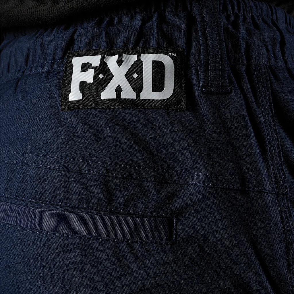 Close up back waist detail of a pair of navy blue FXD Men's WP-12T Elastic Waist Stretch Ripstop Taped Work Pants (FX02606028) on a white background.