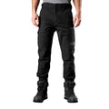 A man wearing black FXD Men's WP-4 Stretch Cuffed Work Pants (FX01616003) with cargo pockets and elastic cuffed ankles, paired with black work boots, shown against a plain white background.