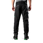 A back view of a man wearing black FXD Men's WP-4 Stretch Cuffed Work Pants (FX01616003) with cargo pockets and elastic cuffed ankles, paired with black work boots, shown against a plain white background.