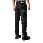 A 3-4 back view of a man wearing black FXD Men's WP-4 Stretch Cuffed Work Pants (FX01616003) with cargo pockets and elastic cuffed ankles, paired with black work boots, shown against a plain white background.