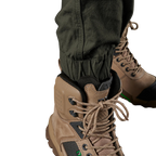 Close up cuff detail on a pair of green FXD Men's WP-4 Stretch Cuffed Work Pants (FX01616003) paired with wheat coloured work boots shown against a plain white background.