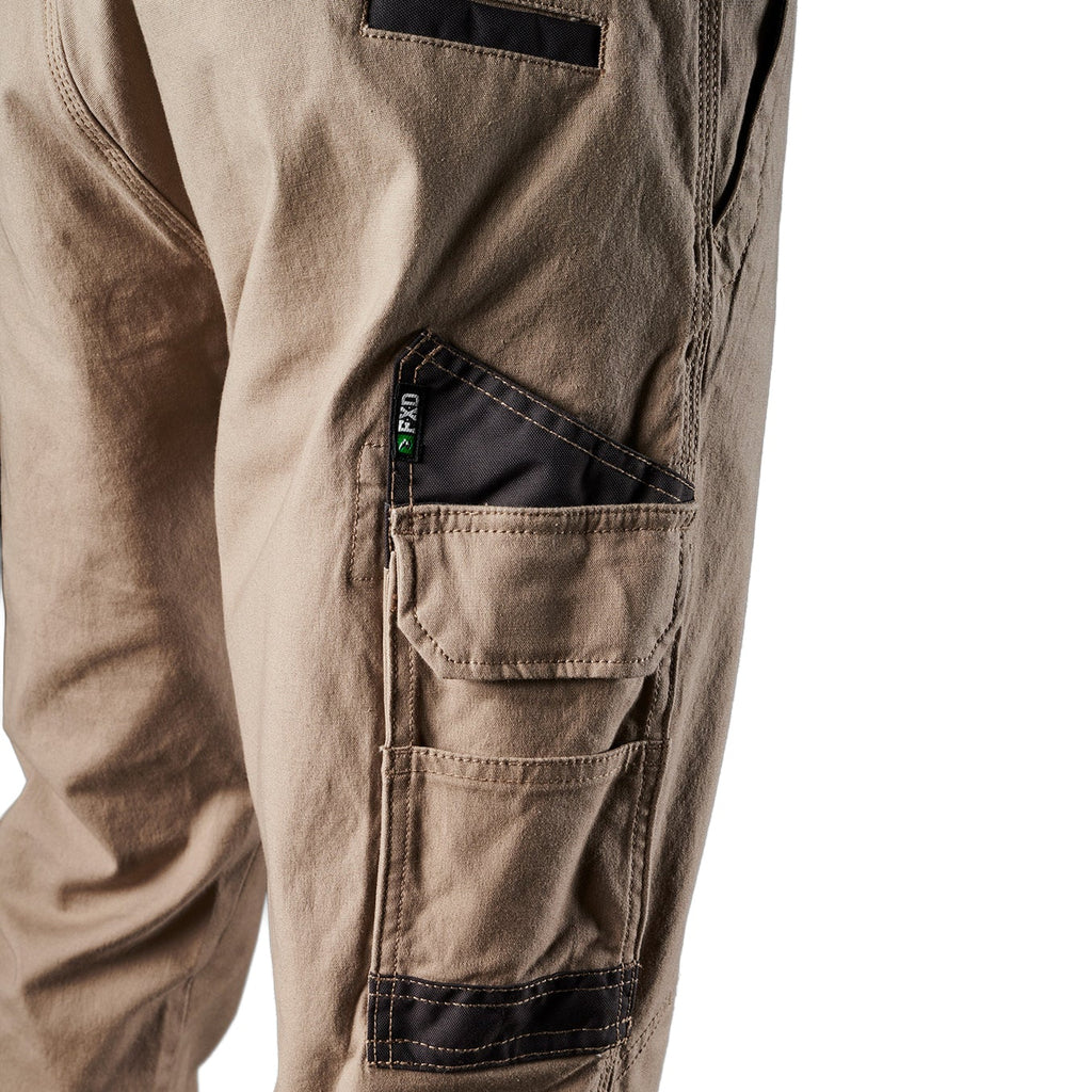 Close up pocket detail on a pair of khaki FXD Men's WP-4 Stretch Cuffed Work Pants (FX01616003) with cargo pockets, shown against a plain white background.