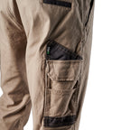 Close up pocket detail on a pair of khaki FXD Men's WP-4 Stretch Cuffed Work Pants (FX01616003) with cargo pockets, shown against a plain white background.