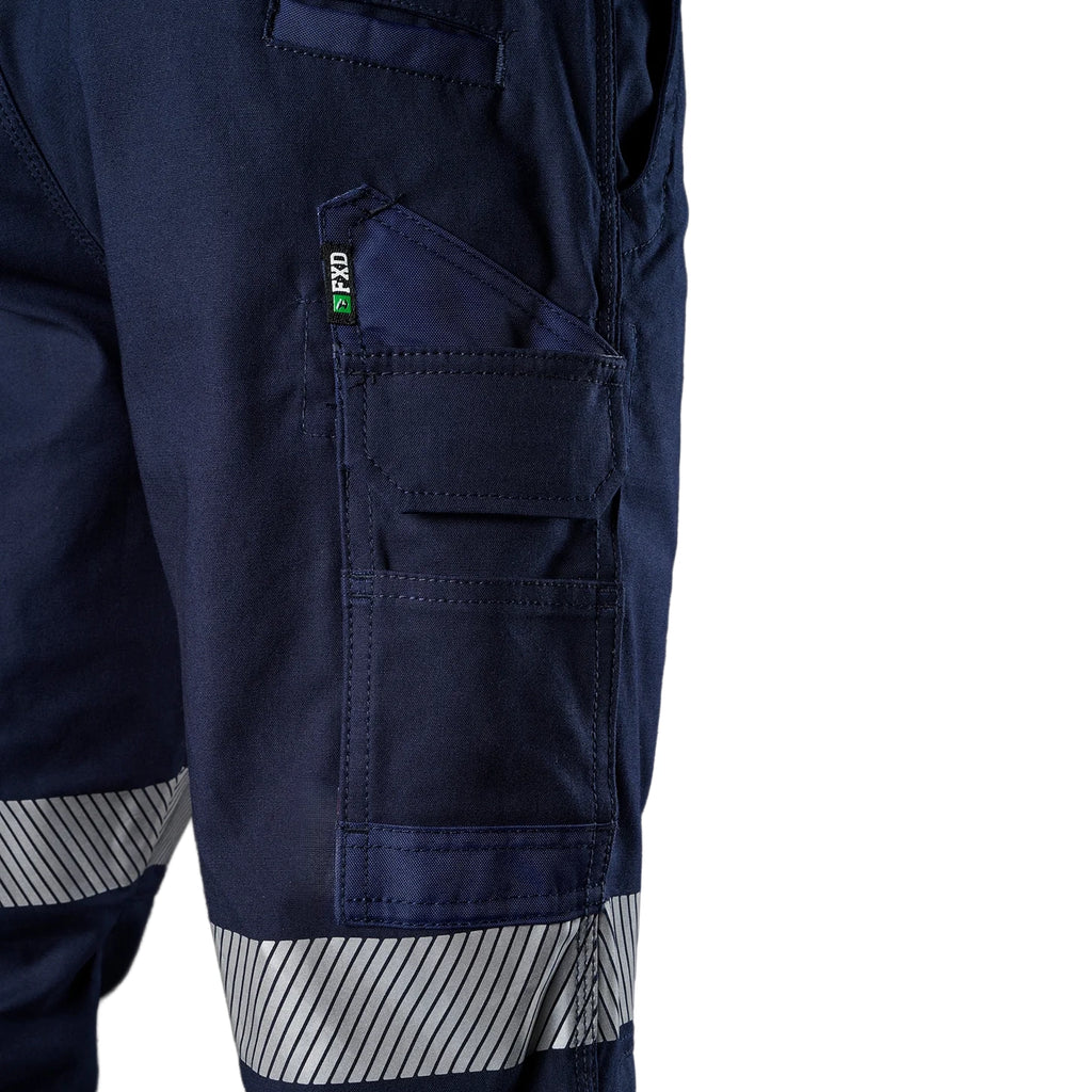 A close up view of the right side pocket detail of a pair of navy blue FXD Men's WP-4T Reflective Cuffed Work Pants (FX02106017) with reflective silver bands on the legs, against a plain white background.