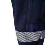 A close up view of the pocket and reflective strip detail on a pair of navy blue FXD Men's WP-4T Reflective Cuffed Work Pants (FX02106017) with reflective silver bands on the legs against a plain white background.