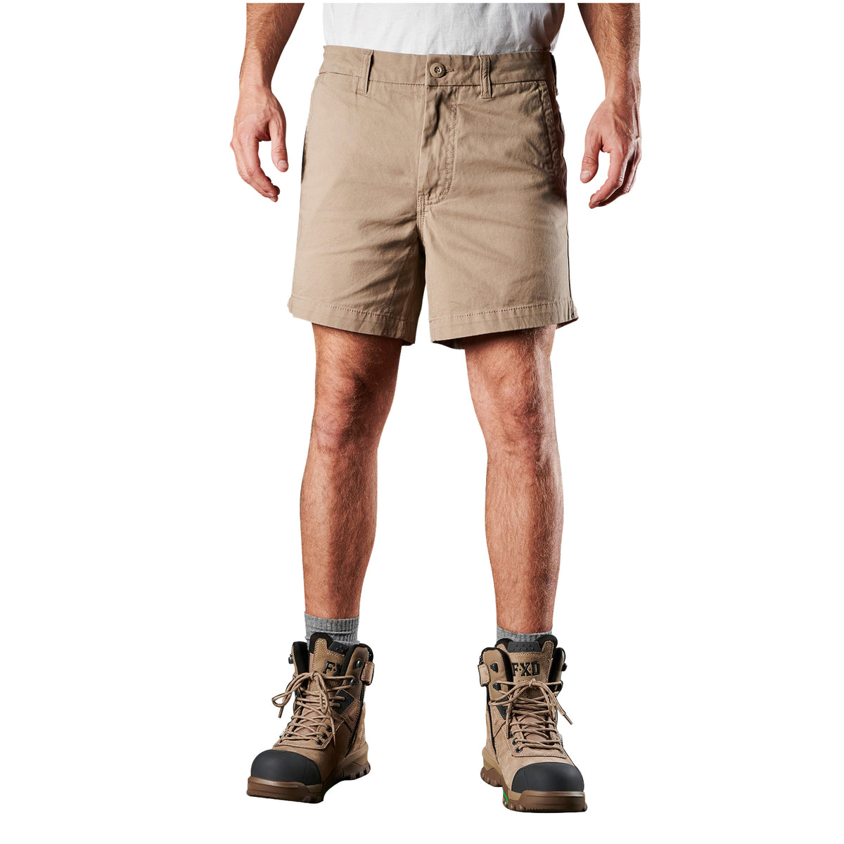 A man modelling a pair of khaki FXD Men's WS-2 Work Shorts (FX01136005) paired with grey socks, and stone FXD work boots against a plain white background.