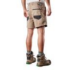 A 3-4 back view of a man modelling a pair of khaki FXD Men's WS-2 Work Shorts (FX01136005) paired with grey socks, and stone FXD work boots against a plain white background.