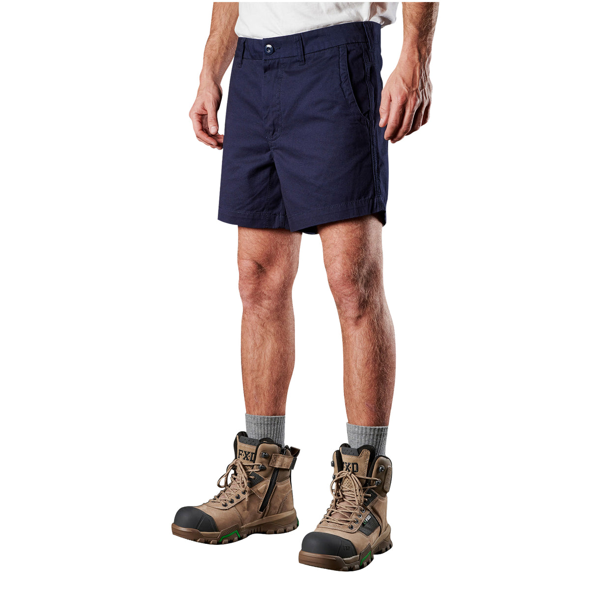 A man modelling navy blue FXD Men's WS-2 Work Shorts (FX01136005), paired with grey socks, and stone FXD work boots, shown from the waist down on a plain white background.