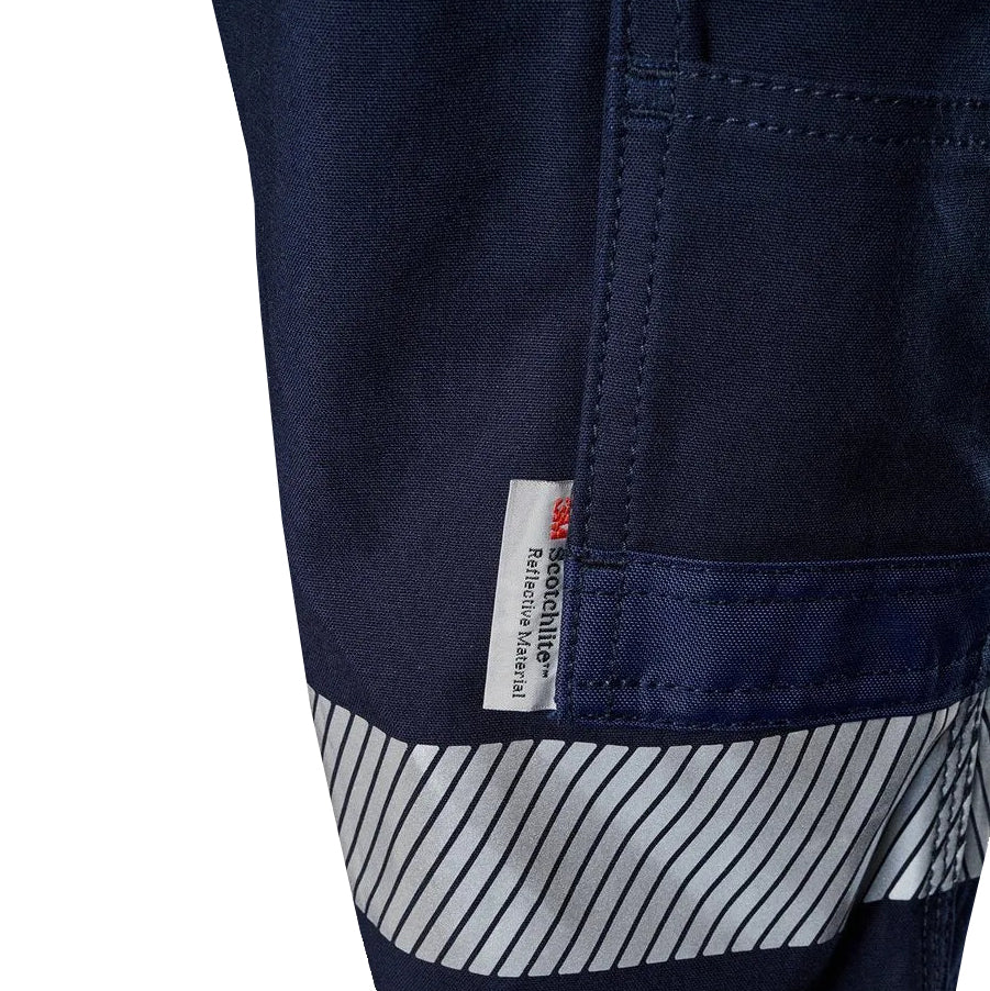 A close up of the detail of navy blue FXD WP-3T Reflective Stretch Work Pants (FX01906010) with reflective silver stripes on the thighs and lower legs, against a white background.