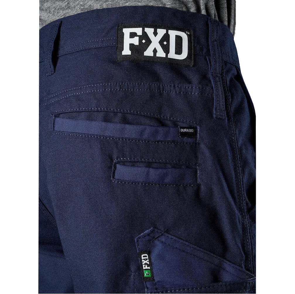 A close up of the waist and pocket detail of the navy blue FXD WP-3T Reflective Stretch Work Pants (FX01906010) against a white background.