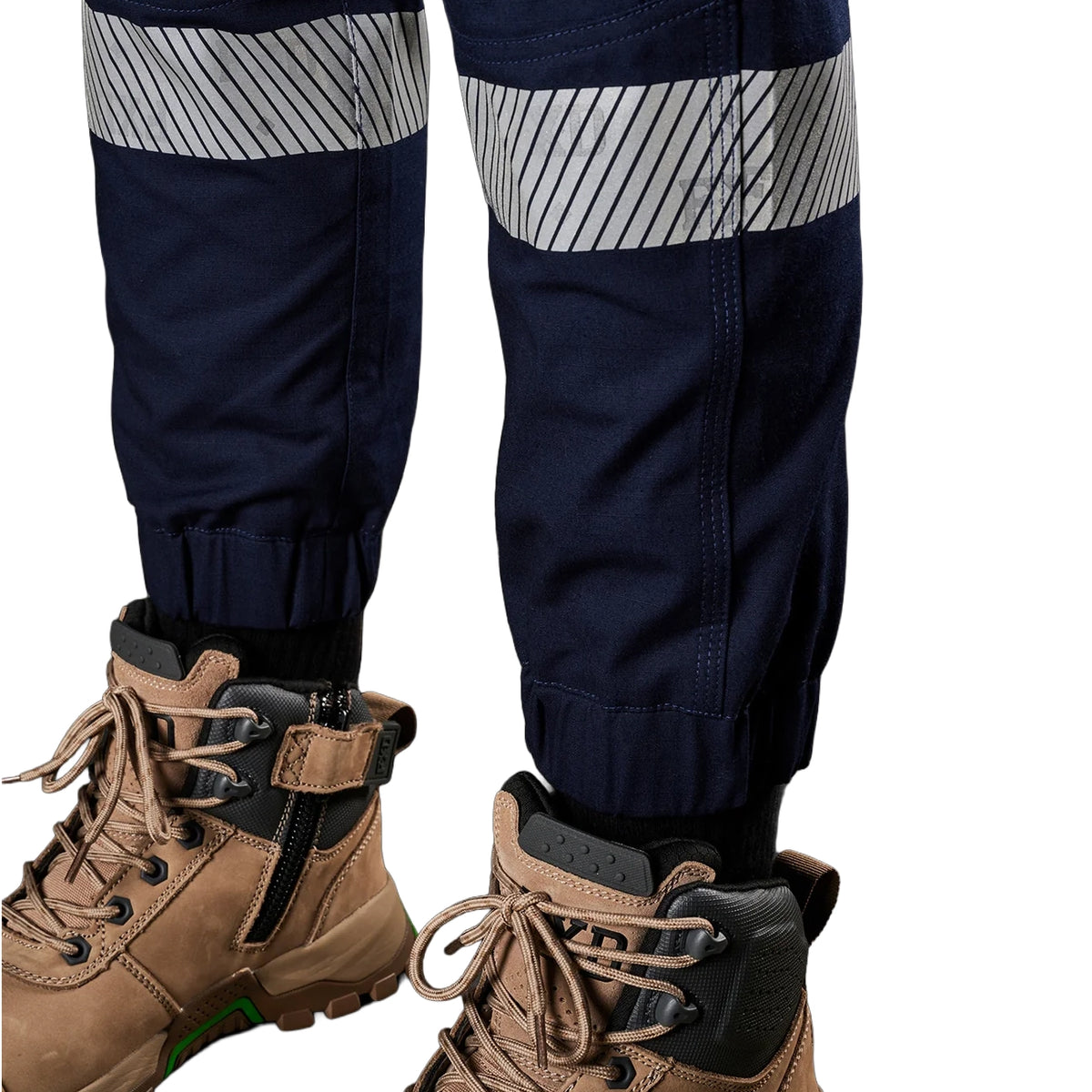 A close up view of the refelctive stip detail on a pair of navy blue FXD Women's Cuffed Taped Work Pants (WP-8WT) paired with stone coloured boots against a plain white background.