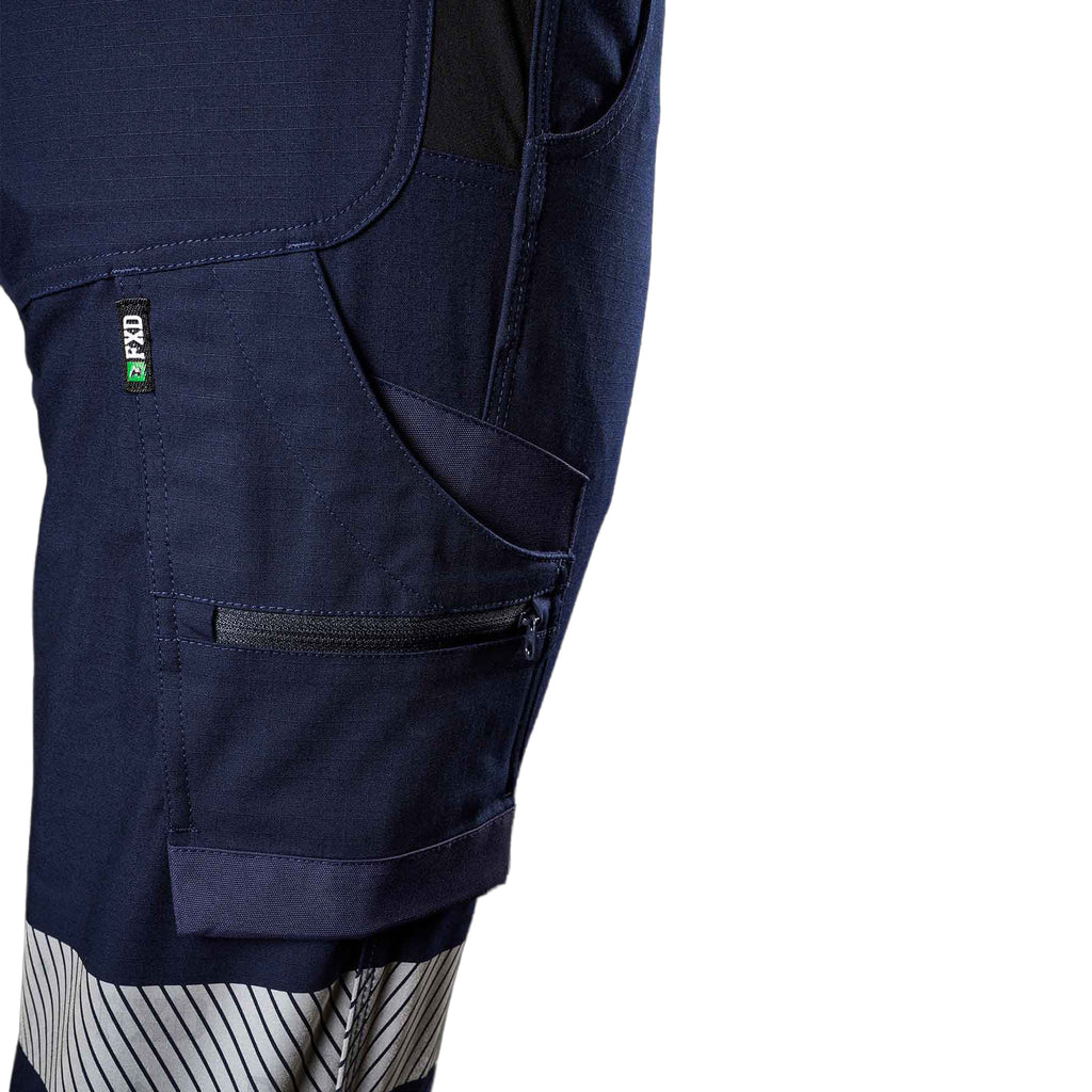 A close up view of the pocket and reflective strip detail of a pair of navy blue FXD Women's Cuffed Taped Work Pants (WP-8WT) against a plain white background.