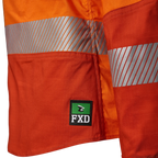 Close up detail of the FXD logo at the hem and tape on an orange FXD Women's LSH-2WT Hi Vis Taped Long Sleeve Work Shirt (FX12404100) on a white background.