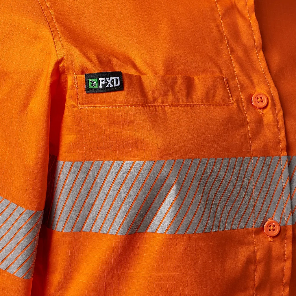 Close up detail of the chest pocket and tape on an orange FXD Women's LSH-2WT Hi Vis Taped Long Sleeve Work Shirt (FX12404100) on a white background.