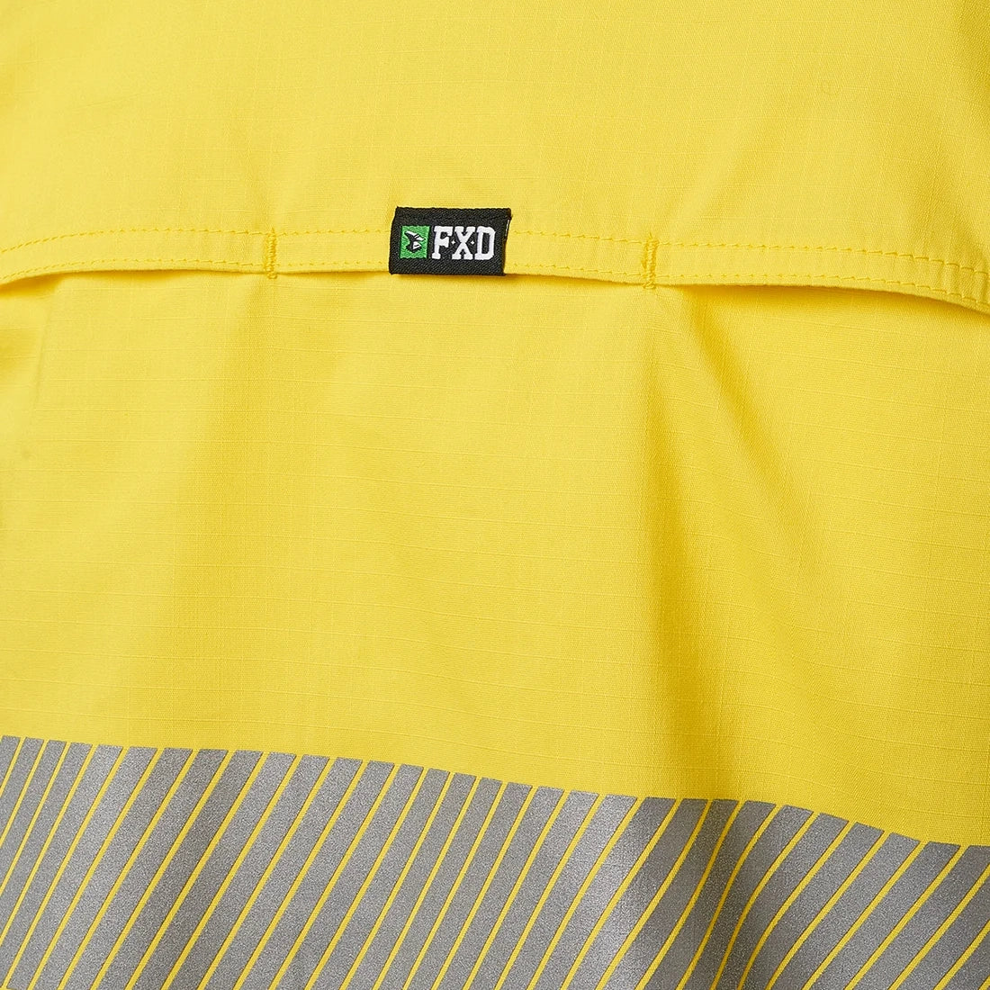 Close up detail of the tape and the back vents on a yellow FXD Women's LSH-2WT Hi Vis Taped Long Sleeve Work Shirt (FX12404100) on a white background.