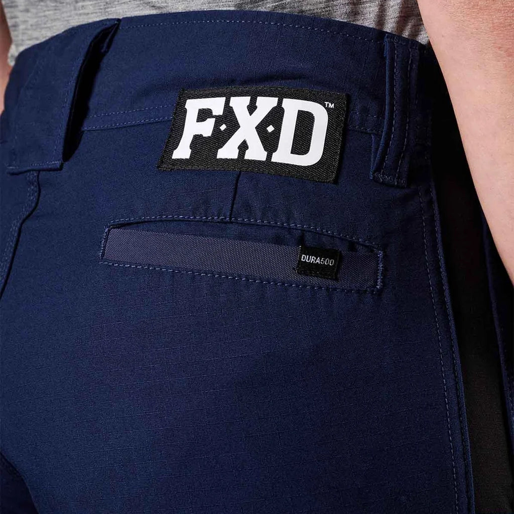 A close up view of the back waist of a pair of navy blue FXD Women's Taped Cargo Work Pants (WP-7WT) paired with a grey t-shirt.