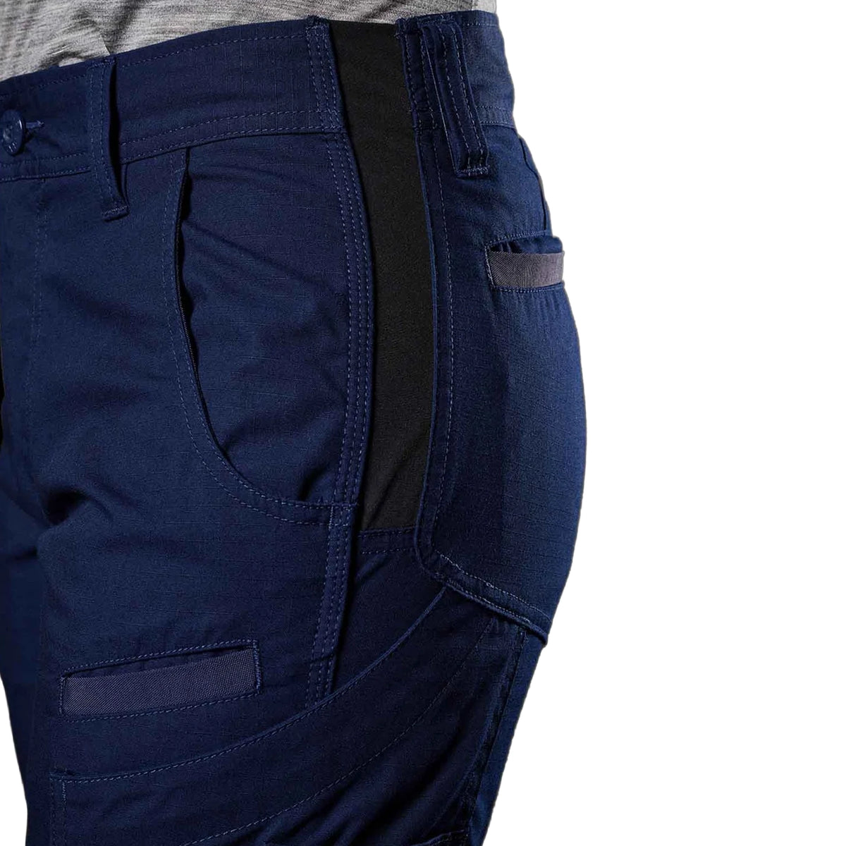 A close up view of the double weave flex hip panel on the navy blue FXD Women's Taped Cargo Work Pants (WP-7WT) paired with a grey t-shirt  against a plain white background.