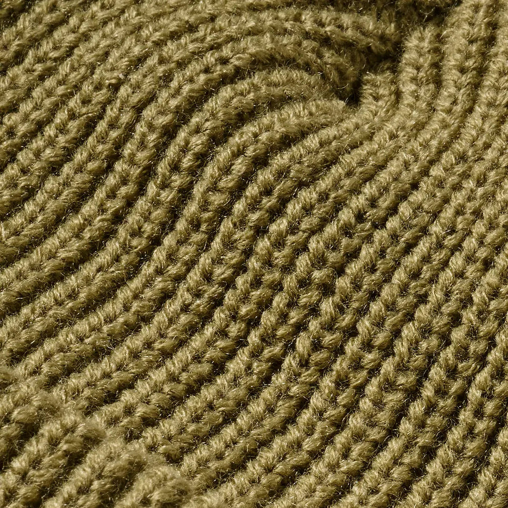 Close up detail of a sage green FXD CP-10 Solid Beanie (FX72509031) OSFM with a brand logo badge on a white background.