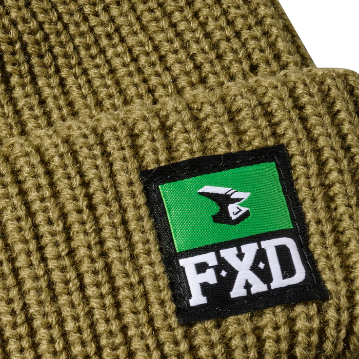 Close up detail of a sage green FXD CP-10 Solid Beanie (FX72509031) OSFM with a brand logo badge on a white background.