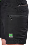 Close-up of black FXD Men's WS-6 Work Shorts (FX02306021) showing a side zippered pocket with a black zipper pull, a top utility pocket, and a green FXD logo patch on the lower leg.