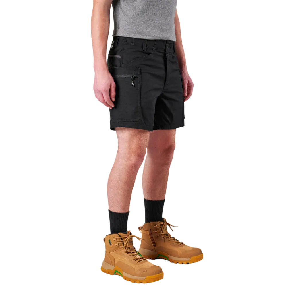 A model from the waist down wearing black FXD Men's WS-6 Work Shorts (FX02306021), black crew socks, and tan work boots against a plain white background.
