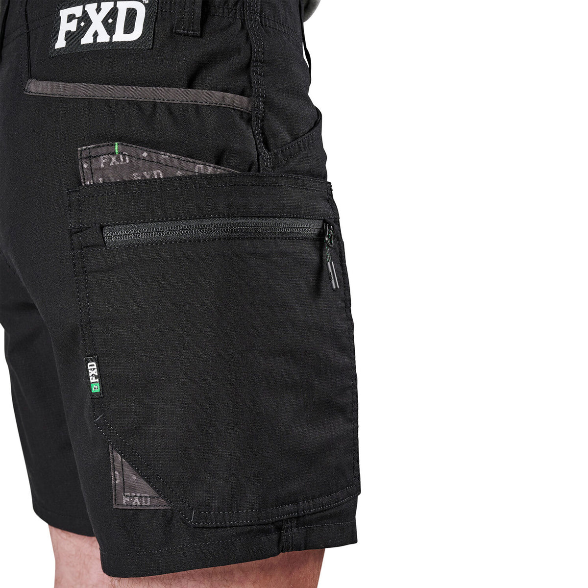 Close-up of black FXD Men's WS-6 Work Shorts (FX02306021 showing the side and back pockets, including a zippered pocket and a patch with FXD branding.