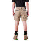 A man modelling khaki FXD Men's WS-7 Work Shorts (FX02306022) with a black tee, black crew socks and stone coloured boots on a white background.