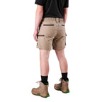 A man modelling khaki FXD Men's WS-7 Work Shorts (FX02306022) with a black tee, black crew socks and stone coloured boots on a white background.
