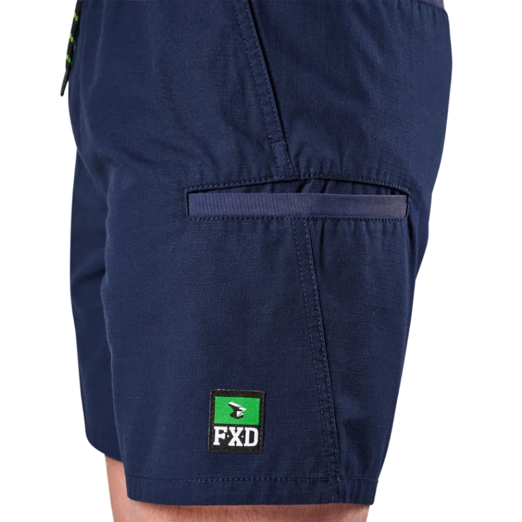 Close-up of navy FXD Men's WS-7 Work Shorts (FX02306022) showing pocket detail an FXD logo patch on the lower leg.