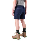 A man modelling navy FXD Men's WS-7 Work Shorts (FX02306022) with a grey tee, black crew socks and stone coloured boots on a white background.