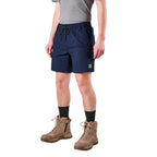 A man modelling navy FXD Men's WS-7 Work Shorts (FX02306022) with a grey tee, black crew socks and stone coloured boots on a white background.