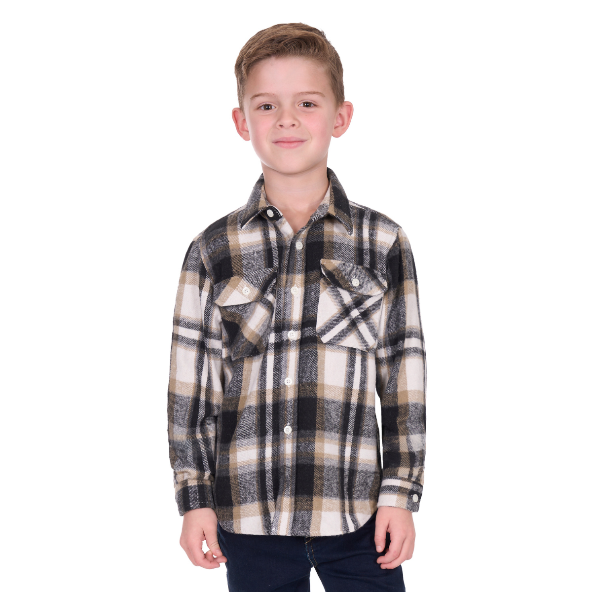 A young boy with short hair smiles at the camera, wearing the Hard Slog Childrens King L/S Thermal Shirt (H6W7115207) in Black/Tan checks and dark pants, standing against a white background.
