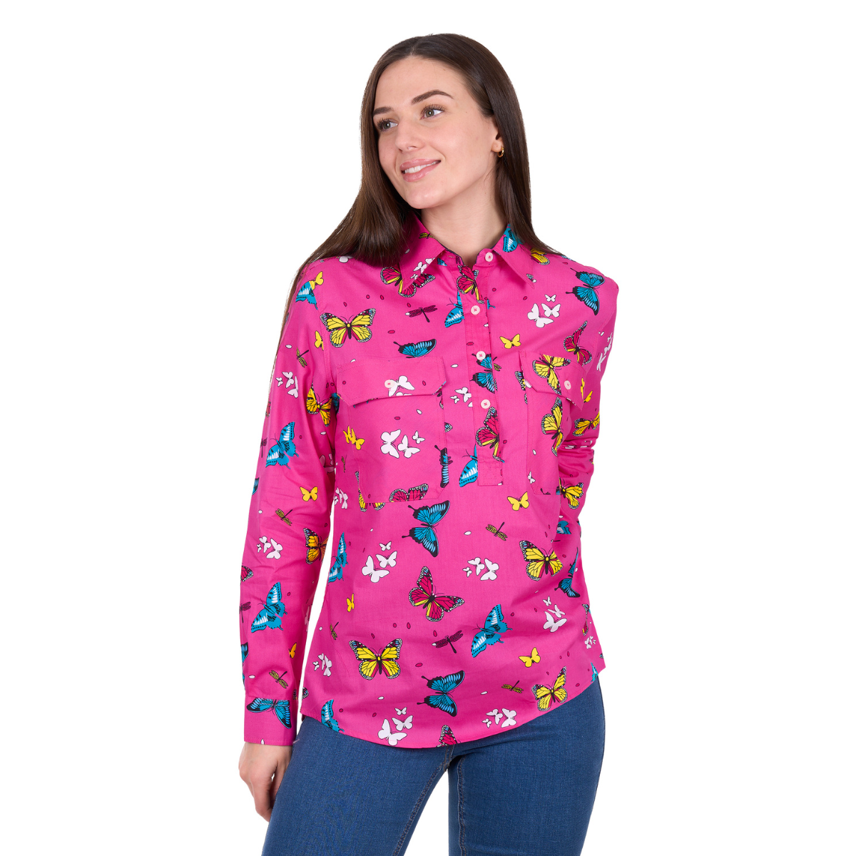 A woman wearing the Hard Slog Womens Gizelle Half Button L/S Shirt (H6W2101169) in hot pink stands smiling with her hand by her side, against a white background.