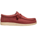 The Hey Dude Mens Wally Stretch Canvas Slip On Shoes in Burnt Red/Boulder Tan feature a red stretch canvas upper, beige speckled sole, visible stitching, cushioned ankle collar, and lace detail near the collar. Brand: Hey Dude.