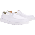 Hey Dude Womens Wendy Stretch Canvas Slip On Shoes (40902-100) in white by Hey Dude, featuring a washed canvas upper, textured lightweight outsole, stitched design, lace-up front, and a small brown tag near the tongue, shown on a plain white background.