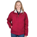 A person with long blonde hair smiles while wearing the Just Country Unisex Diamantina Sherpa Jacket (MWOJ2601) in Very Berry, paired with blue jeans, standing against a plain white background.