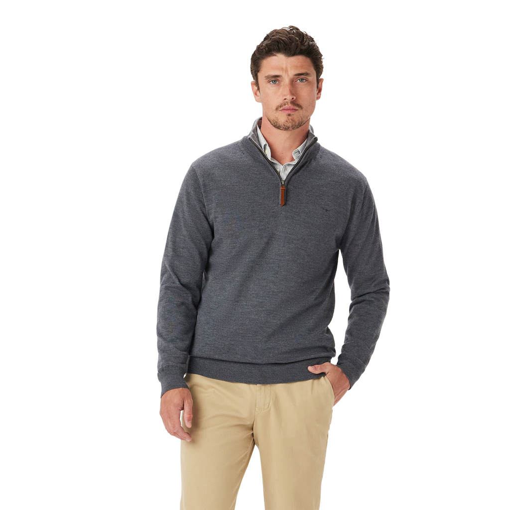 A man with short brown hair wears the R.M.Williams Mens Ernest Merino 1/4 Zip Knit (KZ200WQ16) in Grey Marle over a collared shirt and khaki pants, standing against a plain white background and looking at the camera neutrally.