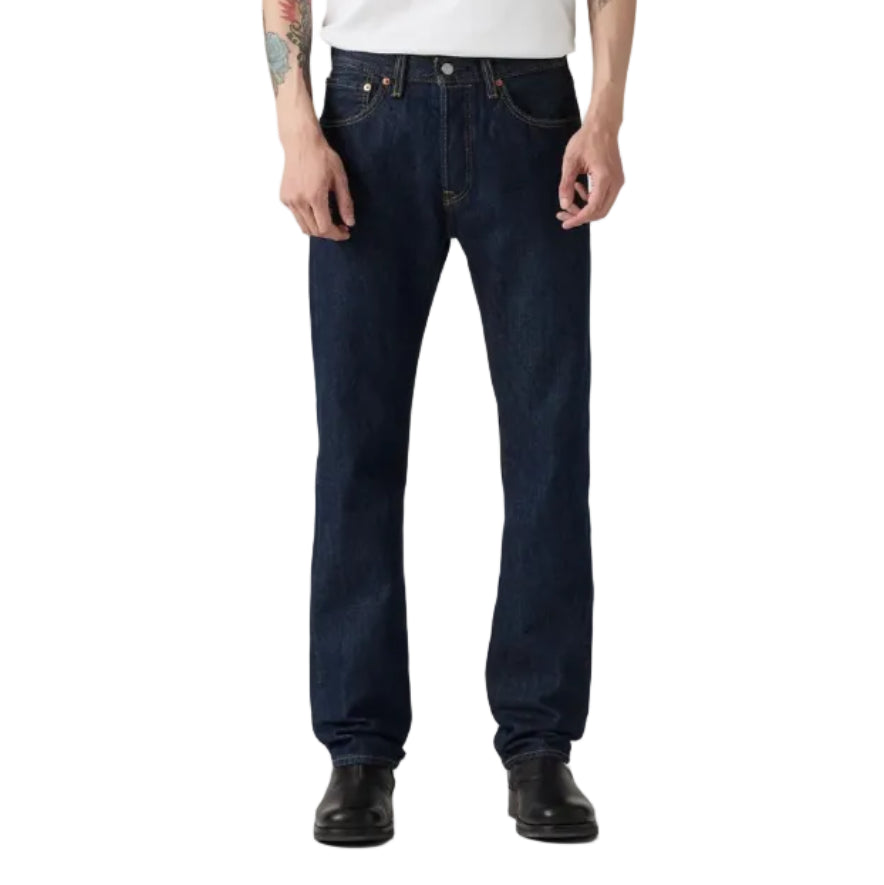 A person wearing Levi's Men's 501 Original Straight Fit Jeans (00501-0115) with a white t-shirt and black boots, shown from the waist down on a solid white background.