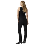 A woman is shown from the back wearing black pants, a black sleeveless top, and black pointed-toe heels against a white studio background.