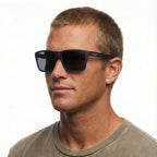 Headshot of a man modelling a pair of Liive Vision Bazza Sunglasses (L0670A) with matte black frames and smoke lenses, shown on a white background.