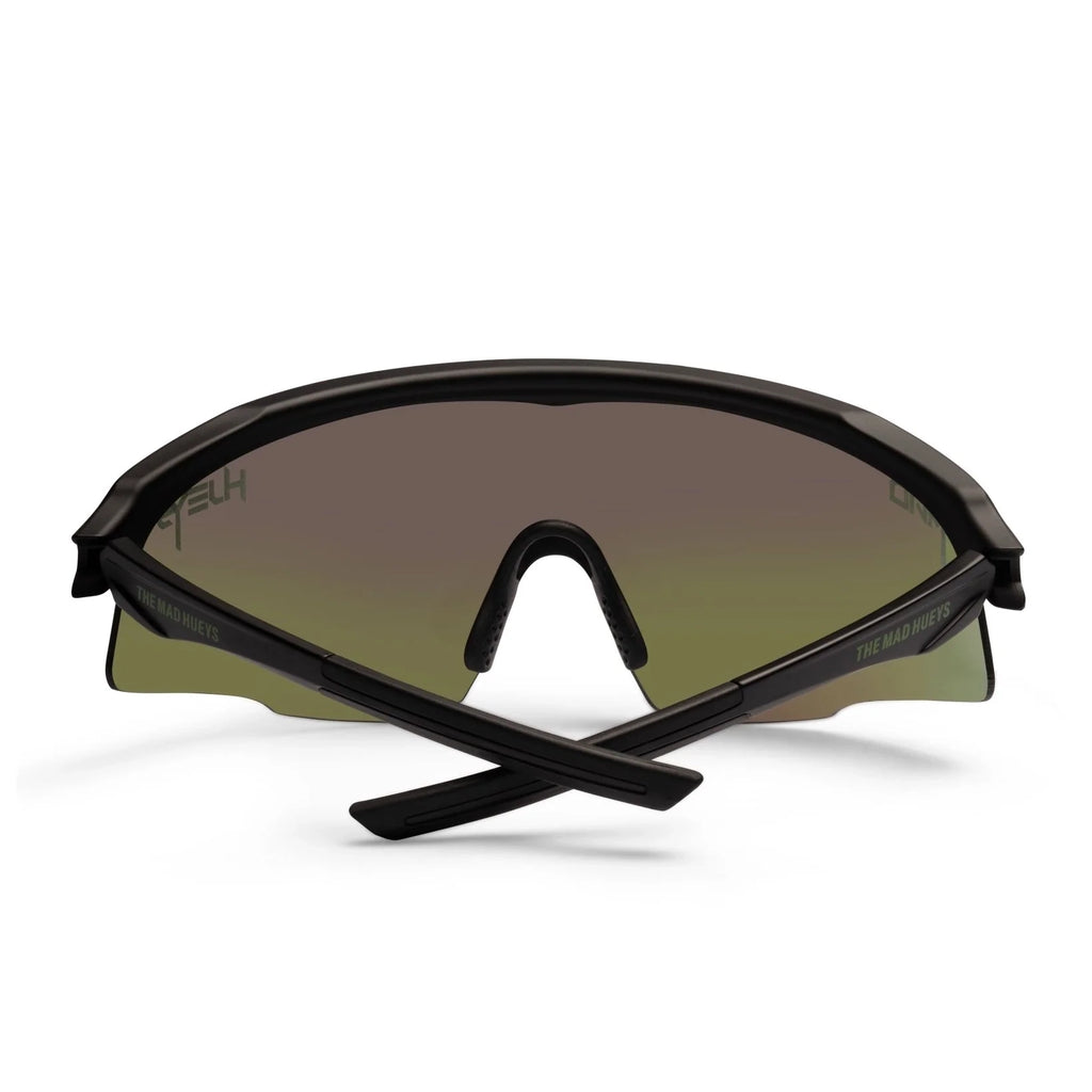 A back folded view of a pair of Liive Vision Dose Sunglasses (L0805A) with a matte black frame and a large shield-style lens featuring a green mirrored finish, shown on a clean white background.