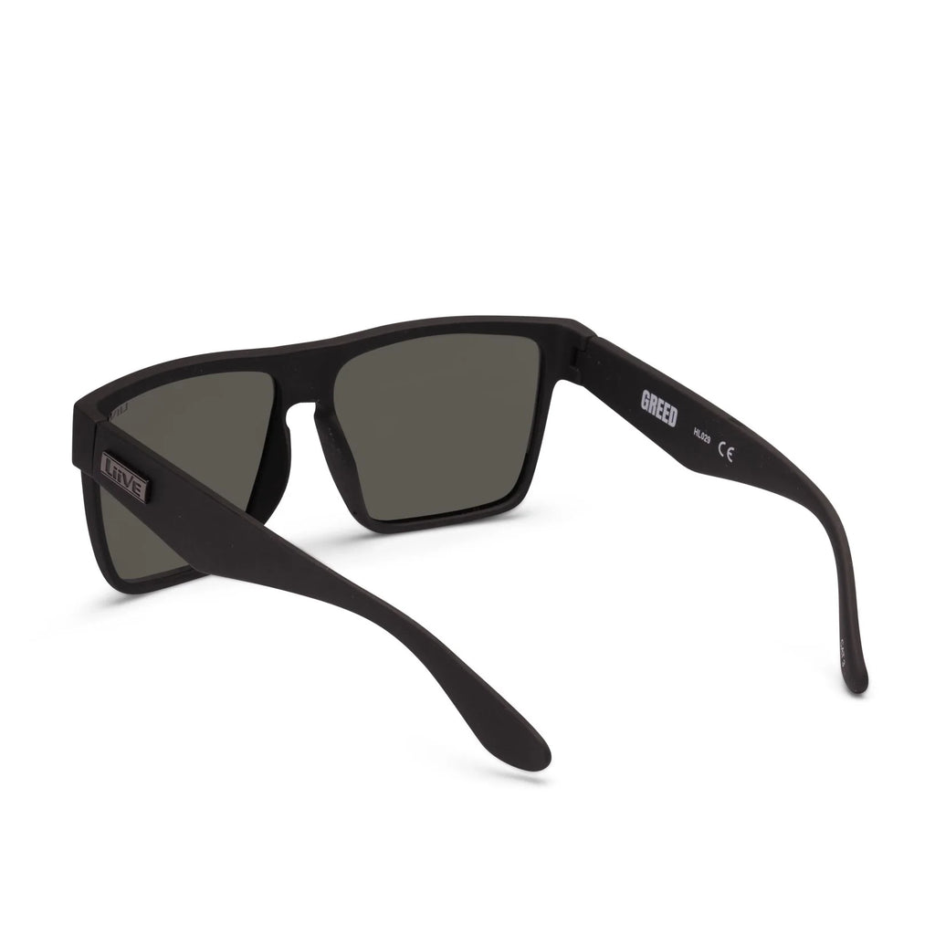 3-4 back view of a pair of matte black Liive Vision Greed Polarised Sunglasses (L0732A) with smoke lenses, featuring the brand name 'LIIVE' printed on the temple and inner lens, on a white background.