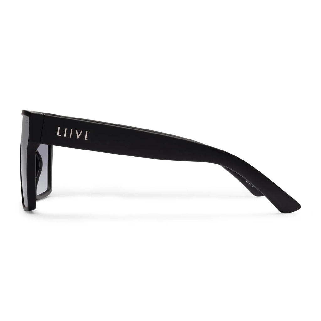 Side view of a pair of matte black square Liive Vision Wasteland Sunglasses (L0827A) with smoke lenses and 'LIIVE' branding on the temple, shown on a clean white background.