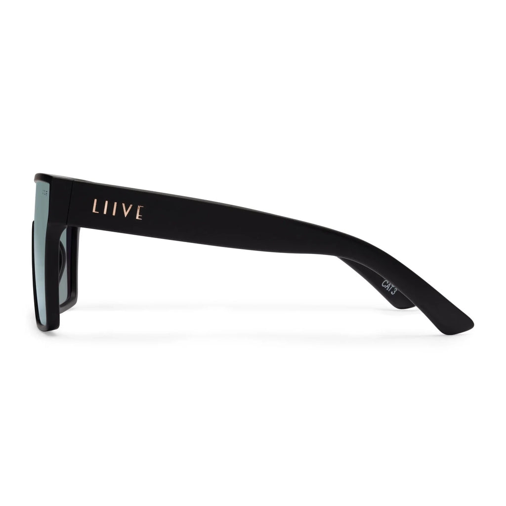 A side view of a pair of Liive Vision Wasteland Sunglasses (L0828B) with matte black frames and mirrored pink lenses, shown against a plain white background.
