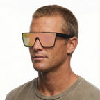 A headshot of a man modelling a pair of Liive Vision Wasteland Sunglasses (L0828B) with matte black frames and mirrored pink lenses, shown against a plain white background.