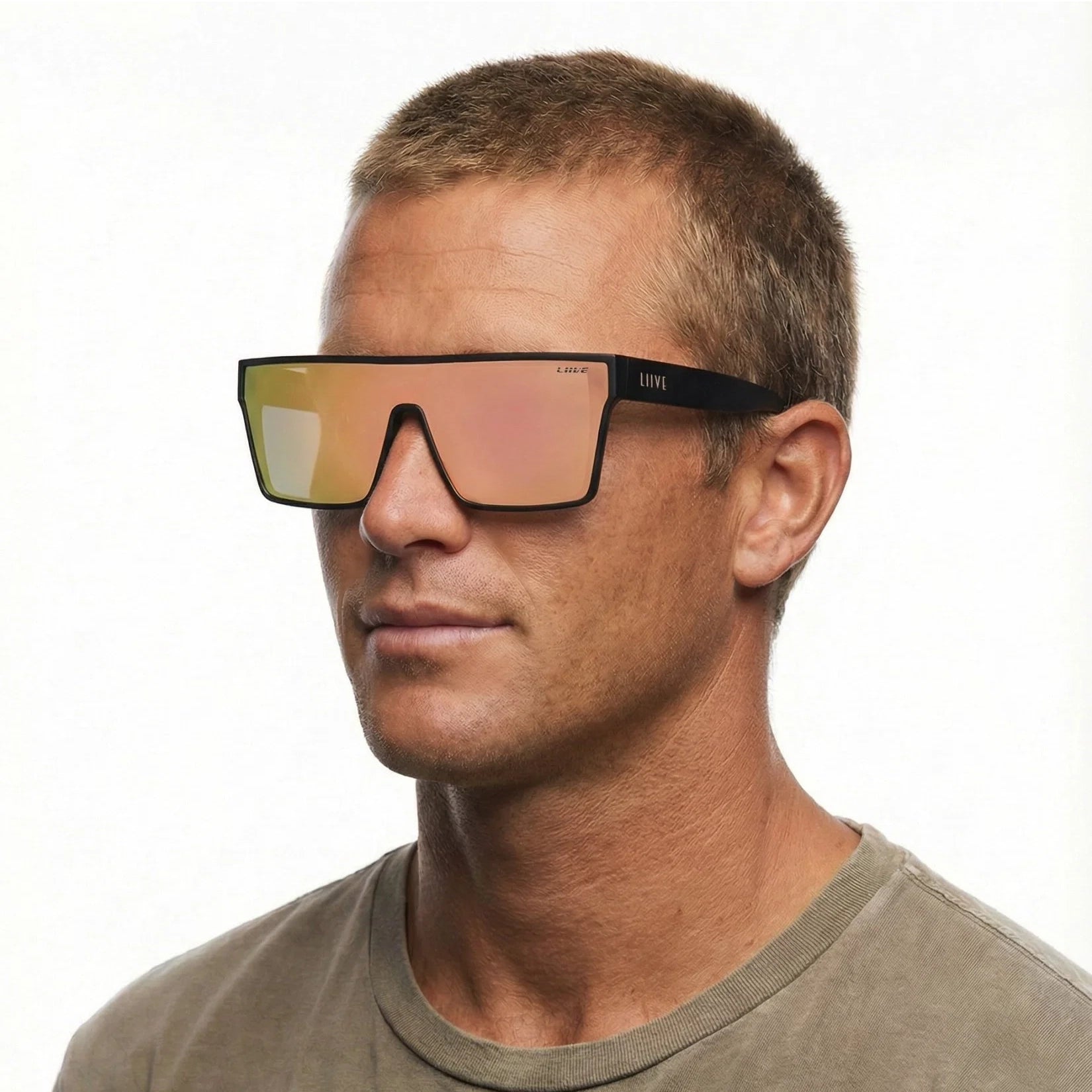 A headshot of a man modelling a pair of Liive Vision Wasteland Sunglasses (L0828B) with matte black frames and mirrored pink lenses, shown against a plain white background.